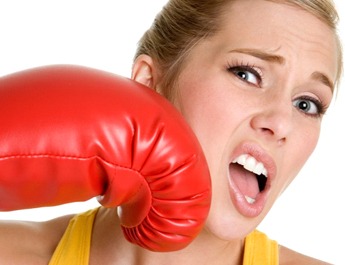 woman getting punched with red boxing glove