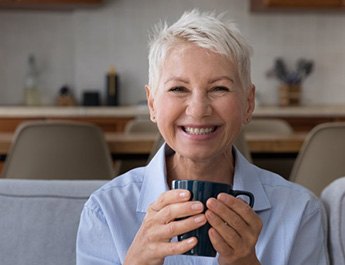 Senior woman smiling with pristine dentures