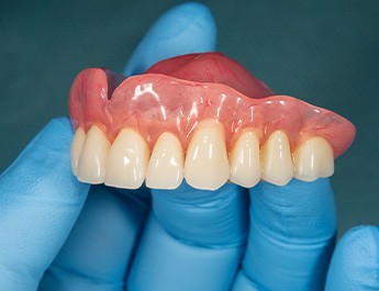 Dentist holding a denture