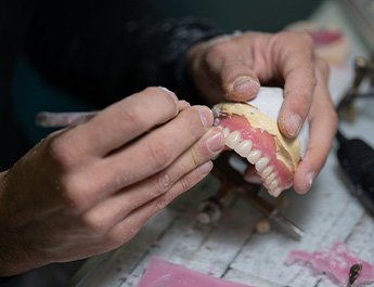 Lab tech carving a denture