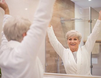 Senior woman celebrating a new opportunity in her bathroom