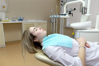woman relaxing and lying back in the dentist chair 