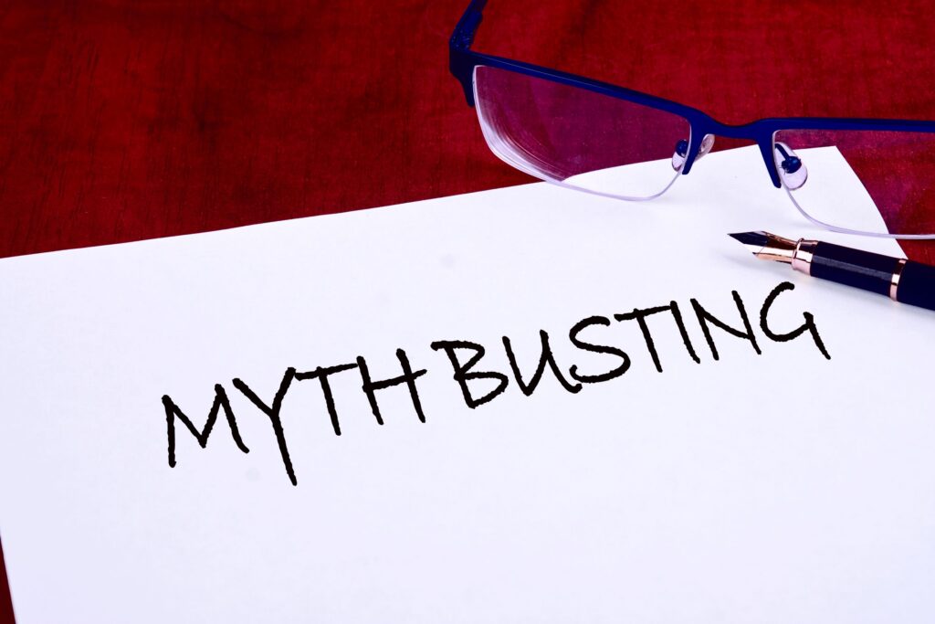 Paper that says "Mythbusting" with a pen and glasses